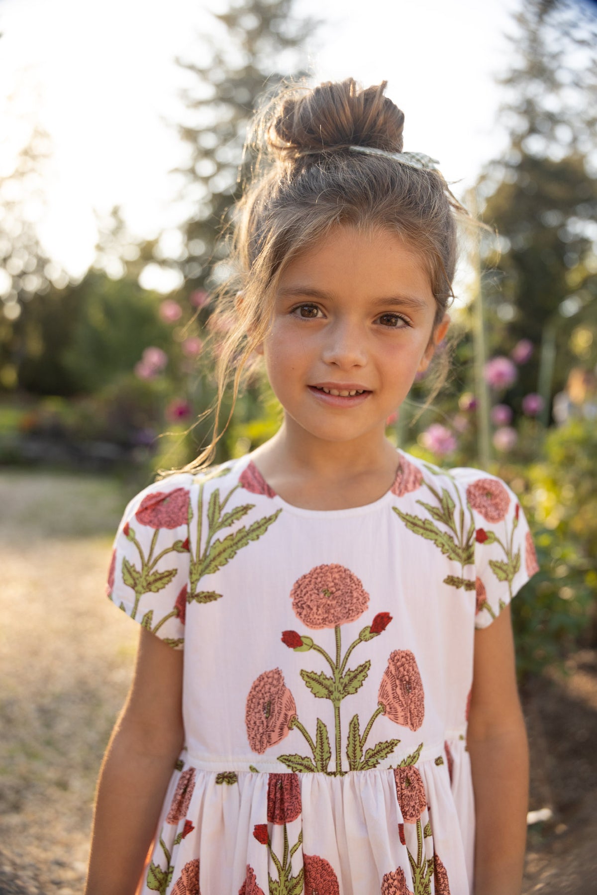 Girls Marisol Dress by Pink Chicken in Rose Dandelion print, featuring a soft pink dress with floral patterns and comfortable fit.