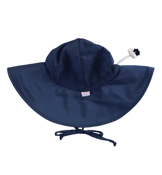 Kids navy sun protective hat by Ruffle Butts with a wide brim and adjustable strap, designed for outdoor sun safety.