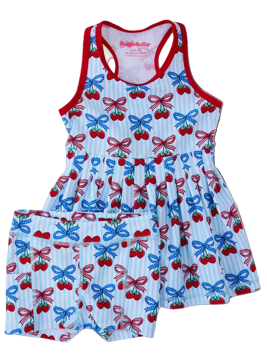 Girls Berries & Bows pleated skirt and active dress set with bike shorts by Ruffle Butts, featuring a colorful berry and bow pattern.