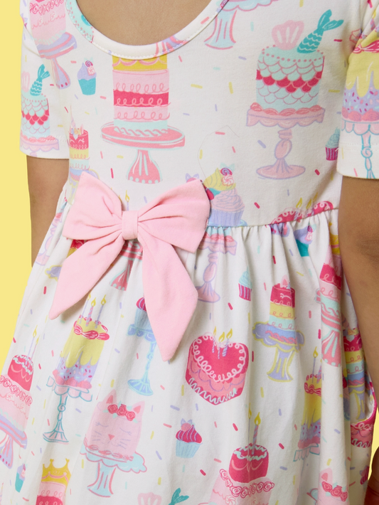 Girls birthday cake party short sleeve knit twirl dress by Ruffle Butts, featuring colorful cake print and comfortable fabric.