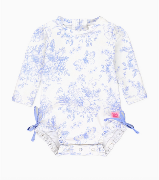 Baby girls’ periwinkle butterfly garden long sleeve rash guard swimsuit by Ruffle Butts, featuring butterfly and floral print.