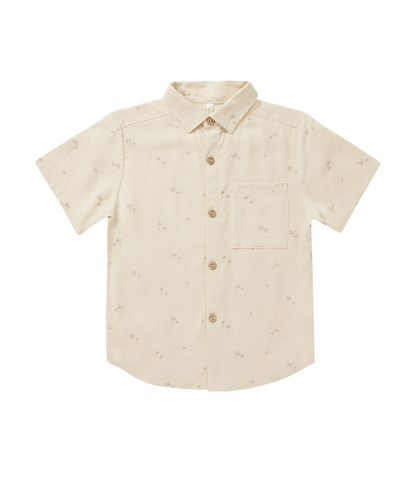 Boy wearing Rylee & Cru palm print collared shirt with short sleeves, featuring a vibrant tropical pattern and classic collar style.