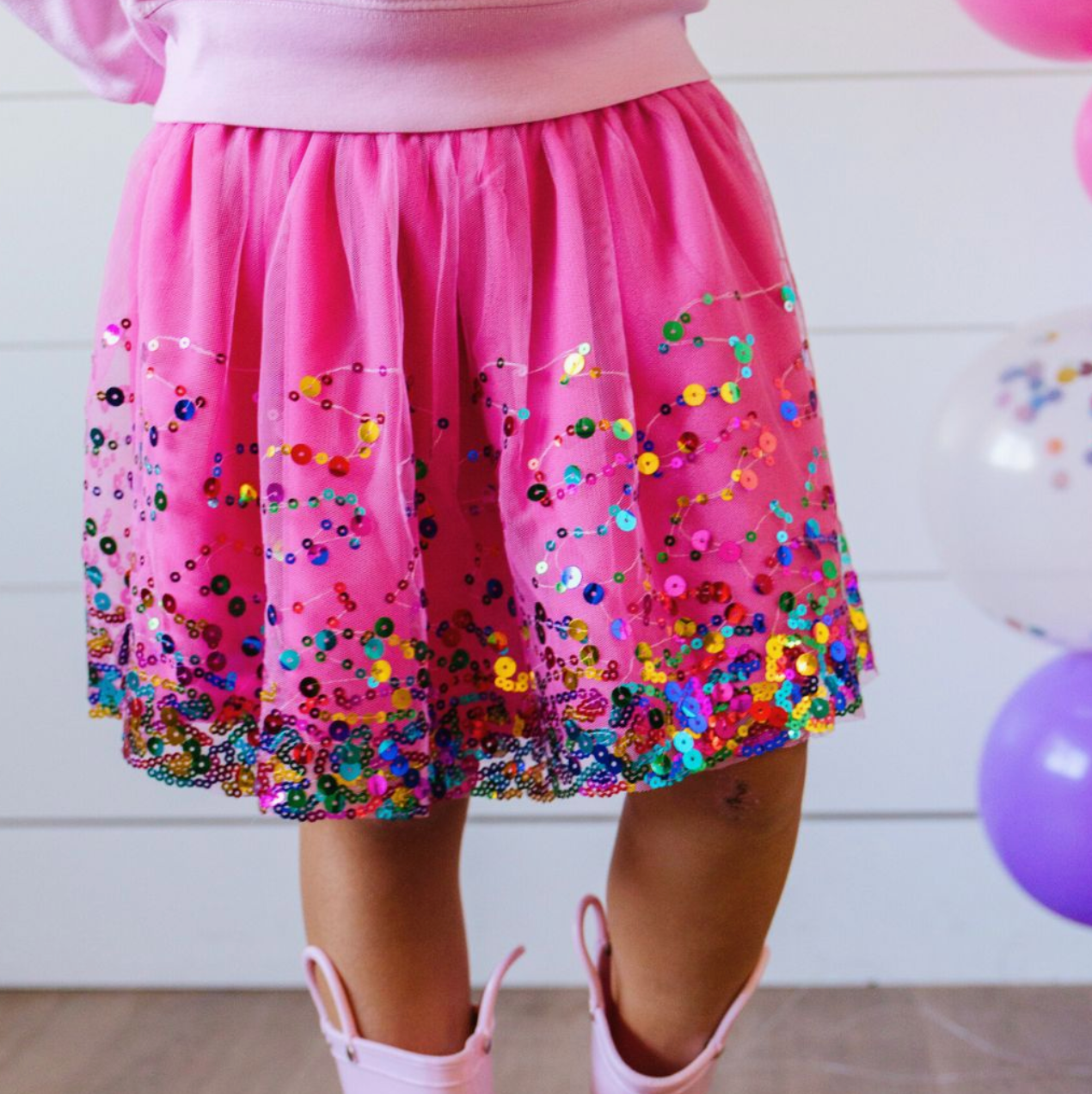 Raspberry confetti tutu from Sweet Wink featuring colorful fabric with confetti pattern, fluffy tulle skirt, perfect for festive occasions.