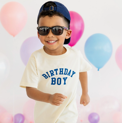 Sweet Wink birthday boy varsity short sleeve T-shirt with bold lettering and colorful design, perfect for celebrating a special day.