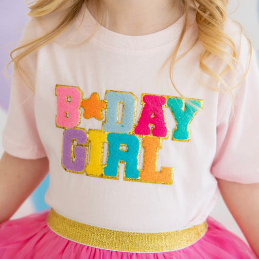 Pink tee shirt with a "Birthday Girl" patch from Sweet Wink, featuring playful lettering and festive design.