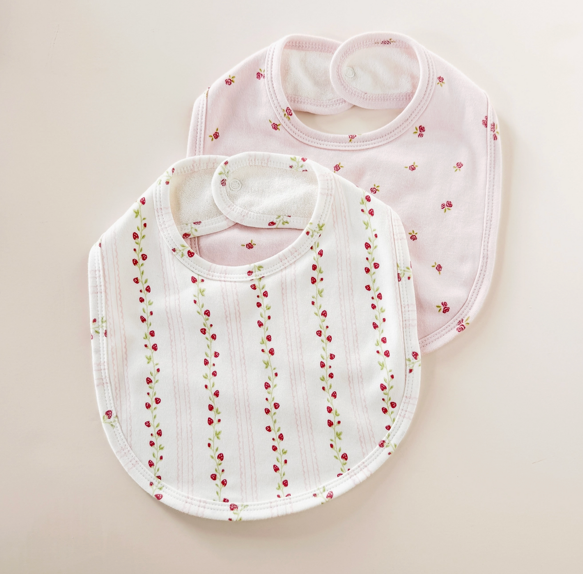 Pink strawberry and rose-themed newborn baby layette set by The Blueberry Hill, featuring soft fabric and adorable design.