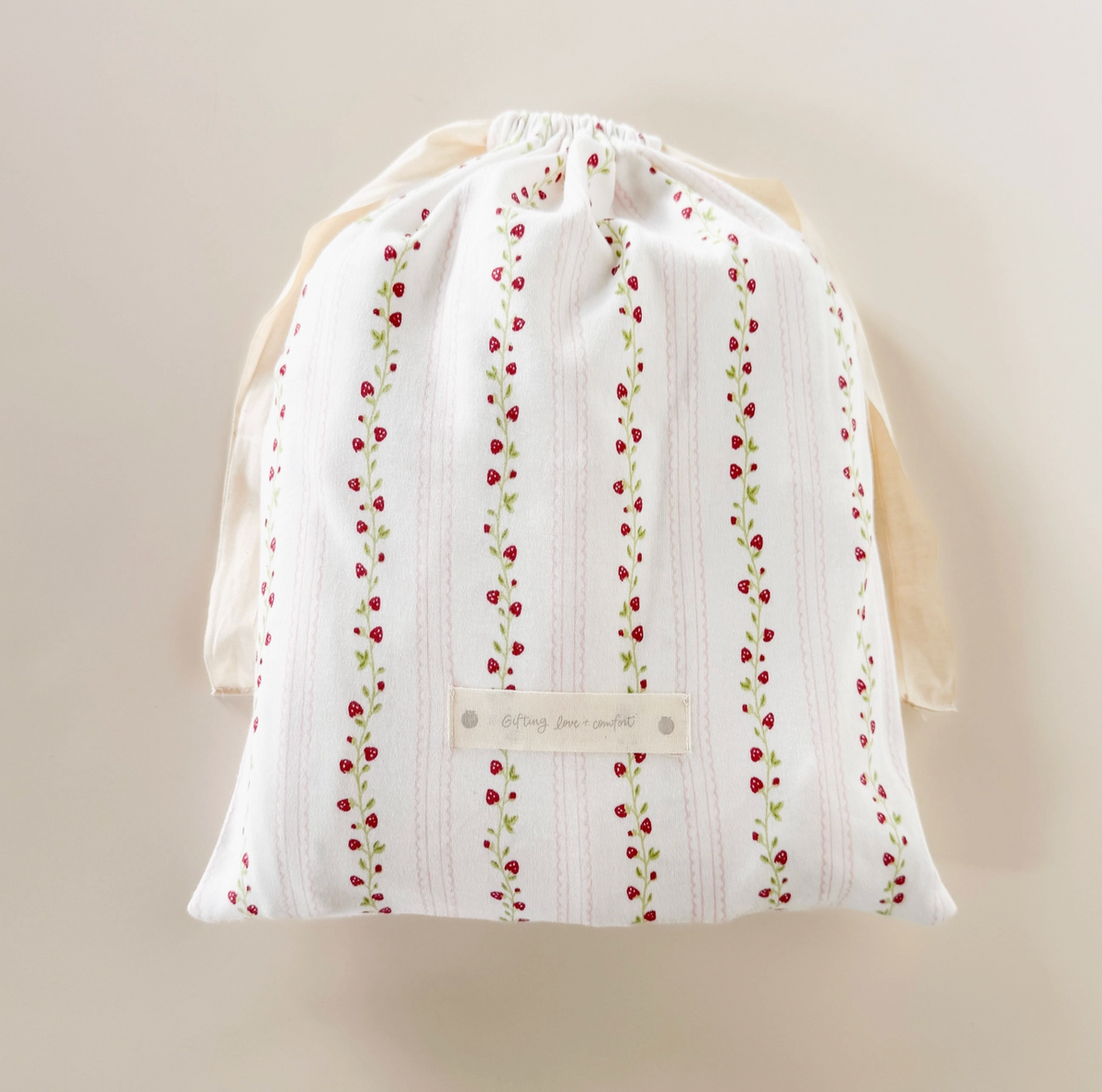 Pink strawberry and rose-themed layette set for newborns by The Blueberry Hill, includes soft baby clothes and accessories for a baby shower gift.