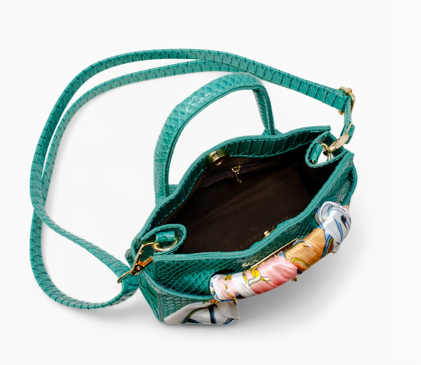 Girl's crocodile-pattern sea green handbag with handle, featuring Tiny Treat and Zomi Gems branding.