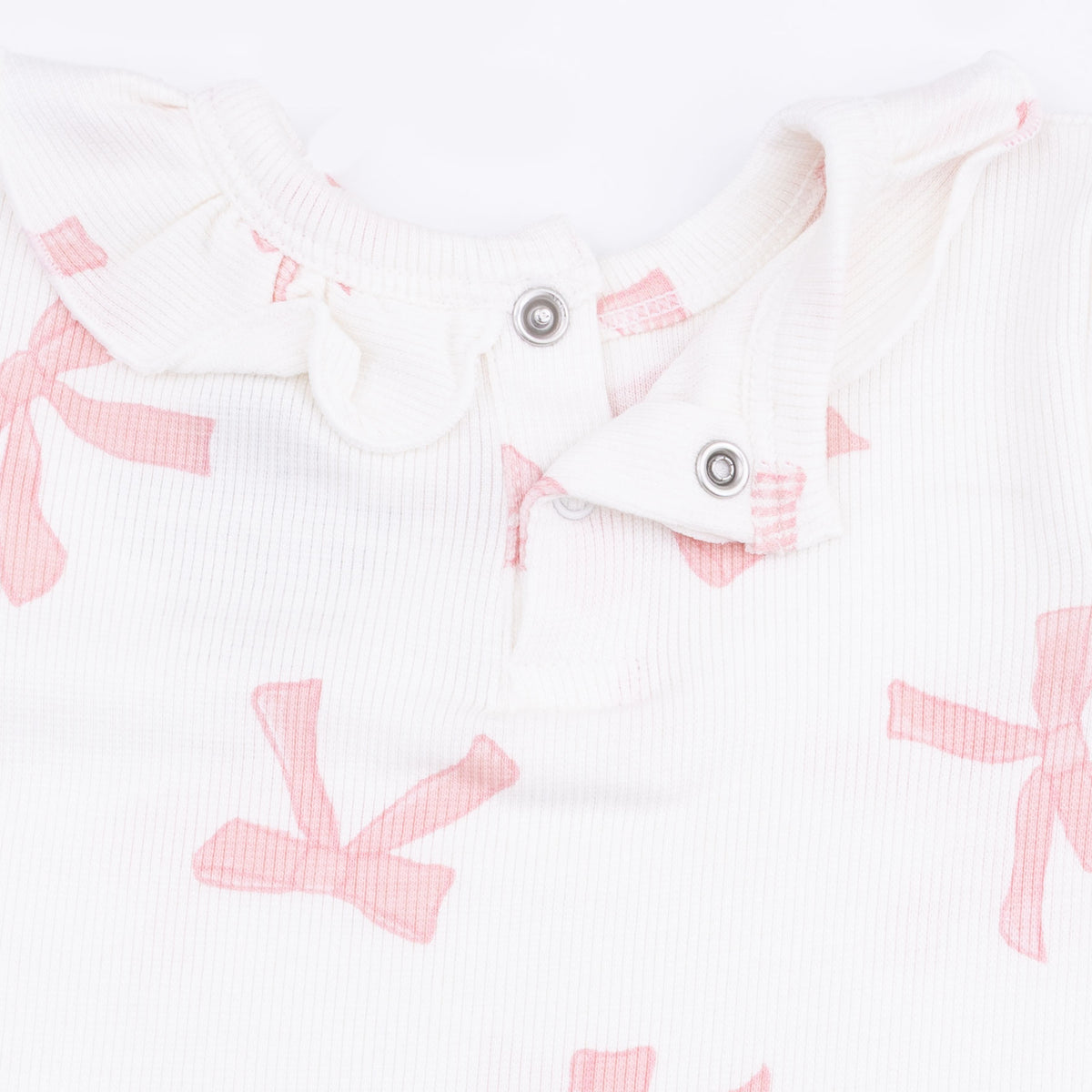 Baby girl wearing Angel Dear long sleeve ruffle top and matching pants set, soft pastel colors, cozy and adorable outfit.