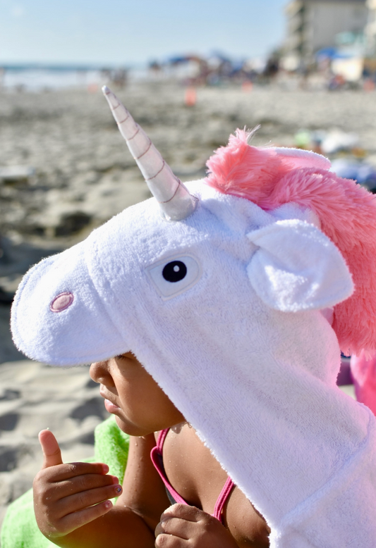 Kids hooded unicorn towel by Yikes Twins featuring colorful unicorn design and soft, absorbent fabric for swimming or bath time.
