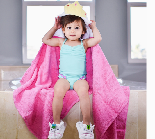 Kids pink princess hooded towel by Yikes Twins featuring a soft pink fabric and a charming princess hood design.