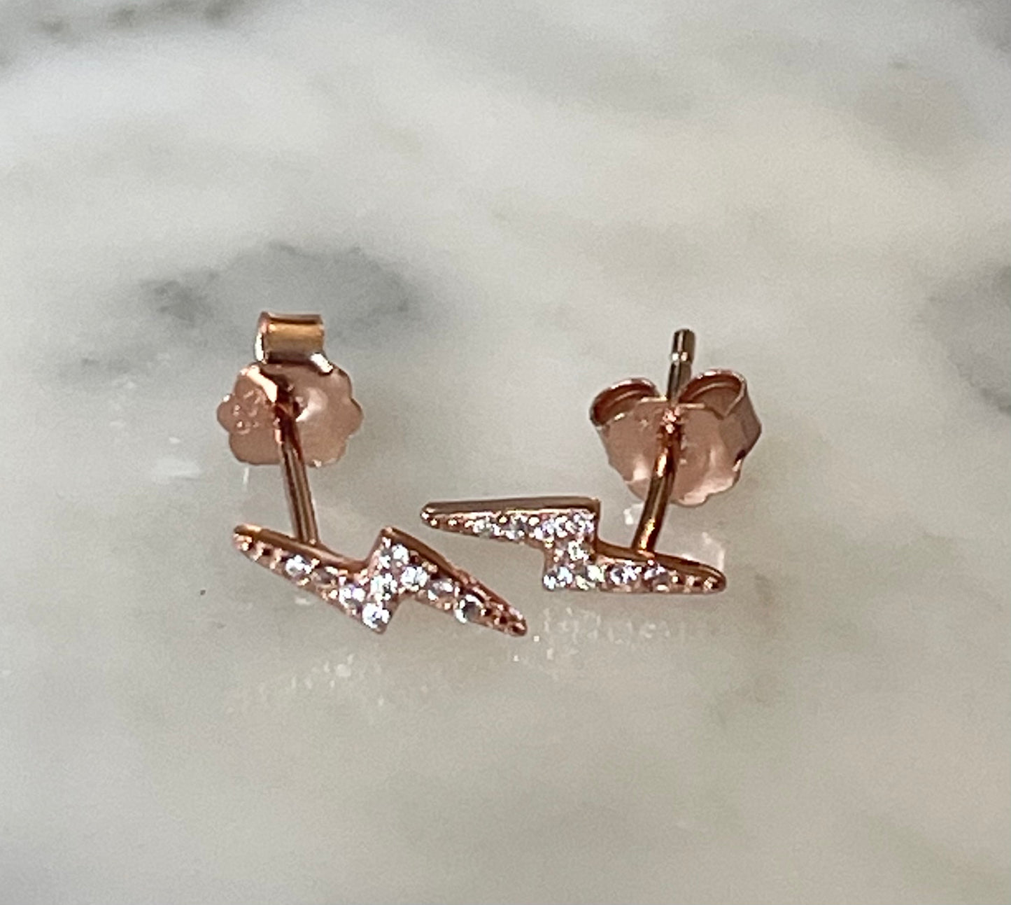 Jack and Jewelz lightning bolt earring with pave stones in three colors, showcasing a bold and sparkling jewelry design.
