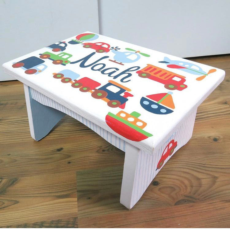 Hand-painted floral foot stool by Flora Ottimer featuring vibrant, artistic design on a wooden base.