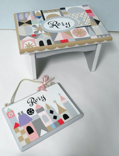 Hand-painted custom foot stool by Flora Ottimer featuring vibrant, artistic design on a wooden stool.