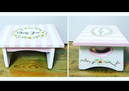 Hand-painted custom foot stool by Flora Ottimer featuring vibrant floral artwork on a wooden stool.