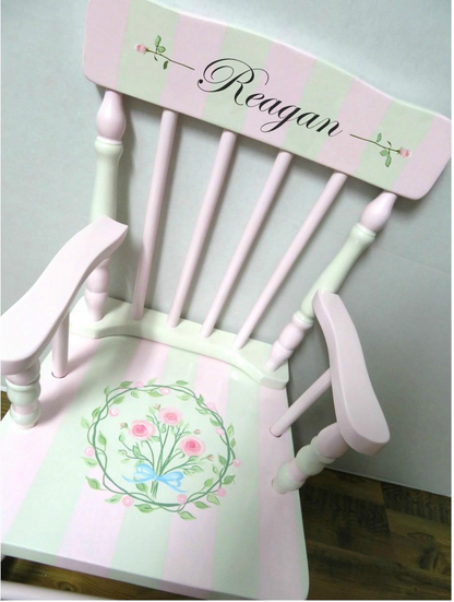 Hand-painted custom rocking chair by Flora Ottimer featuring intricate artwork and a classic wooden design.