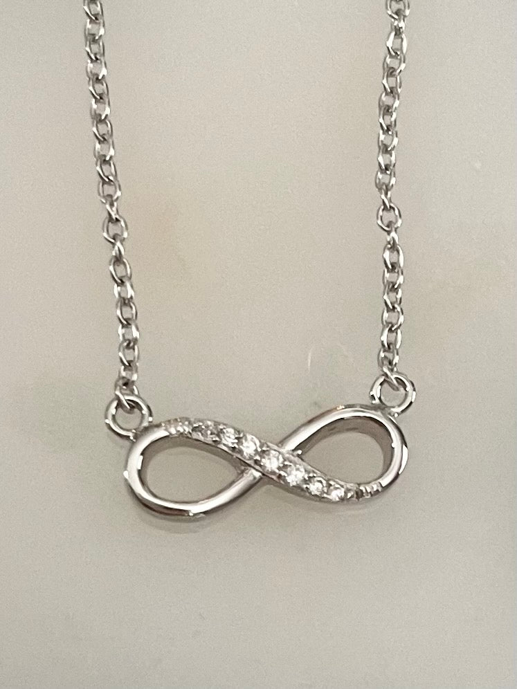 Silver infinity pendant necklace by Jack and Jewelz featuring a sleek, polished infinity symbol on a delicate chain.