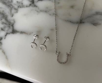 Lucky horse shoe CZ earrings by Jack and Jewelz featuring sparkling cubic zirconia accents on gold-tone horse shoe design.