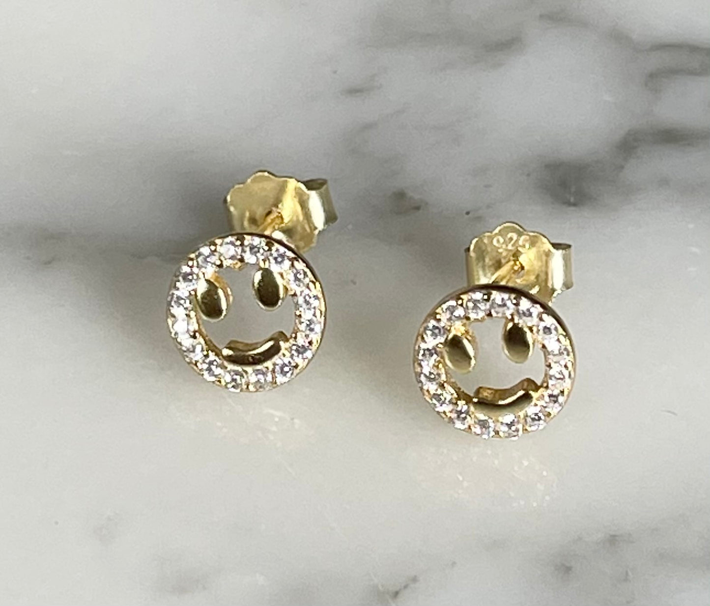 Open smiley face earrings by Jack and Jewelz featuring gold-tone metal and playful smiley design.