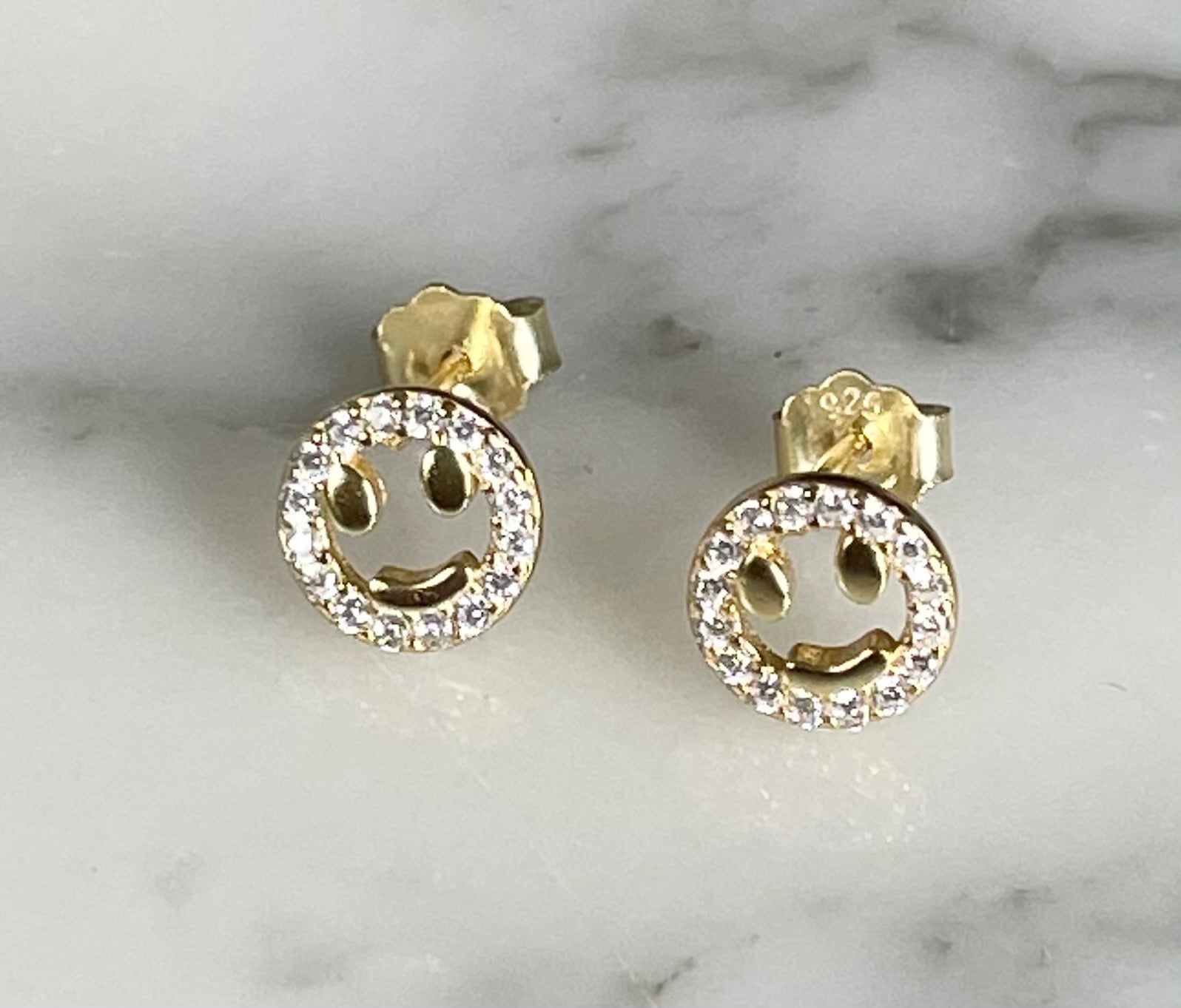 Open smiley face earrings by Jack and Jewelz featuring gold-tone metal and playful smiley design.