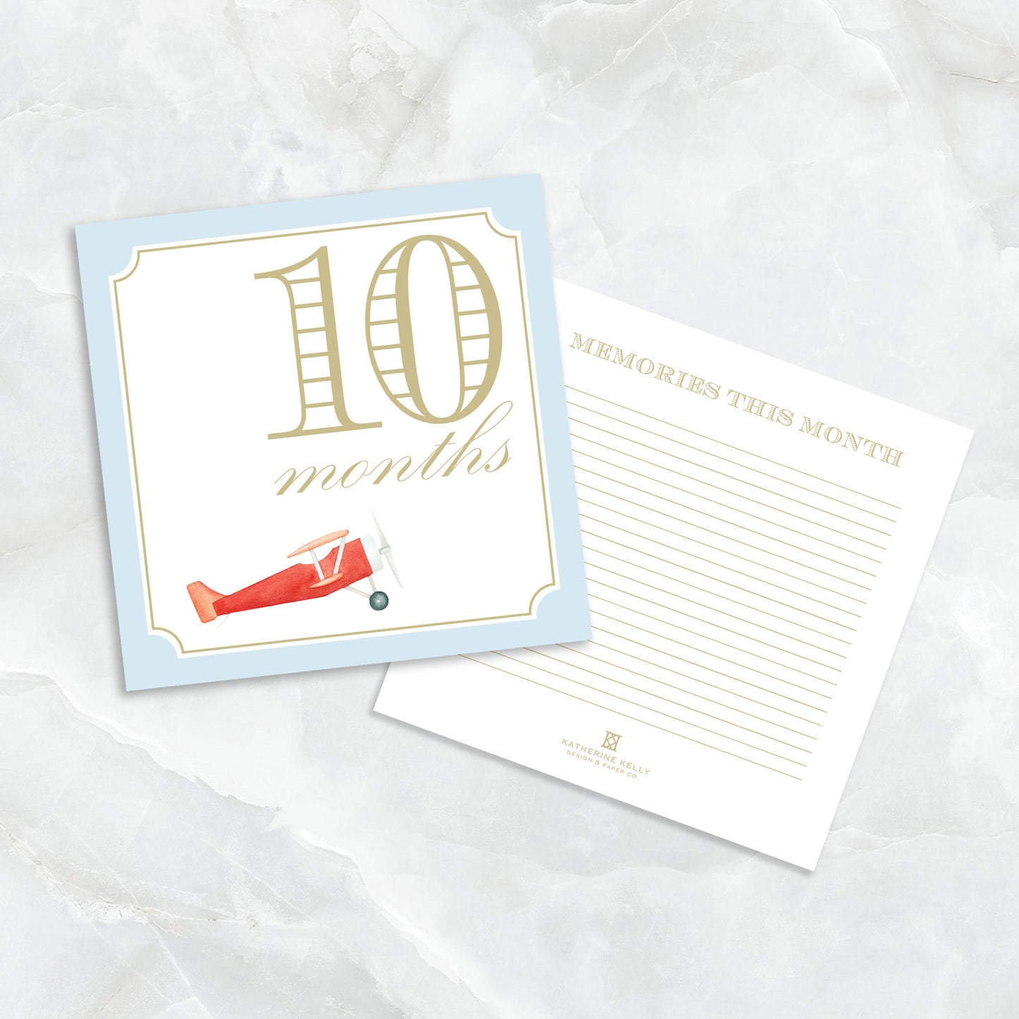 Blue baby milestone card set by Katherine Kelly showing numbered milestone cards for boys with playful designs.