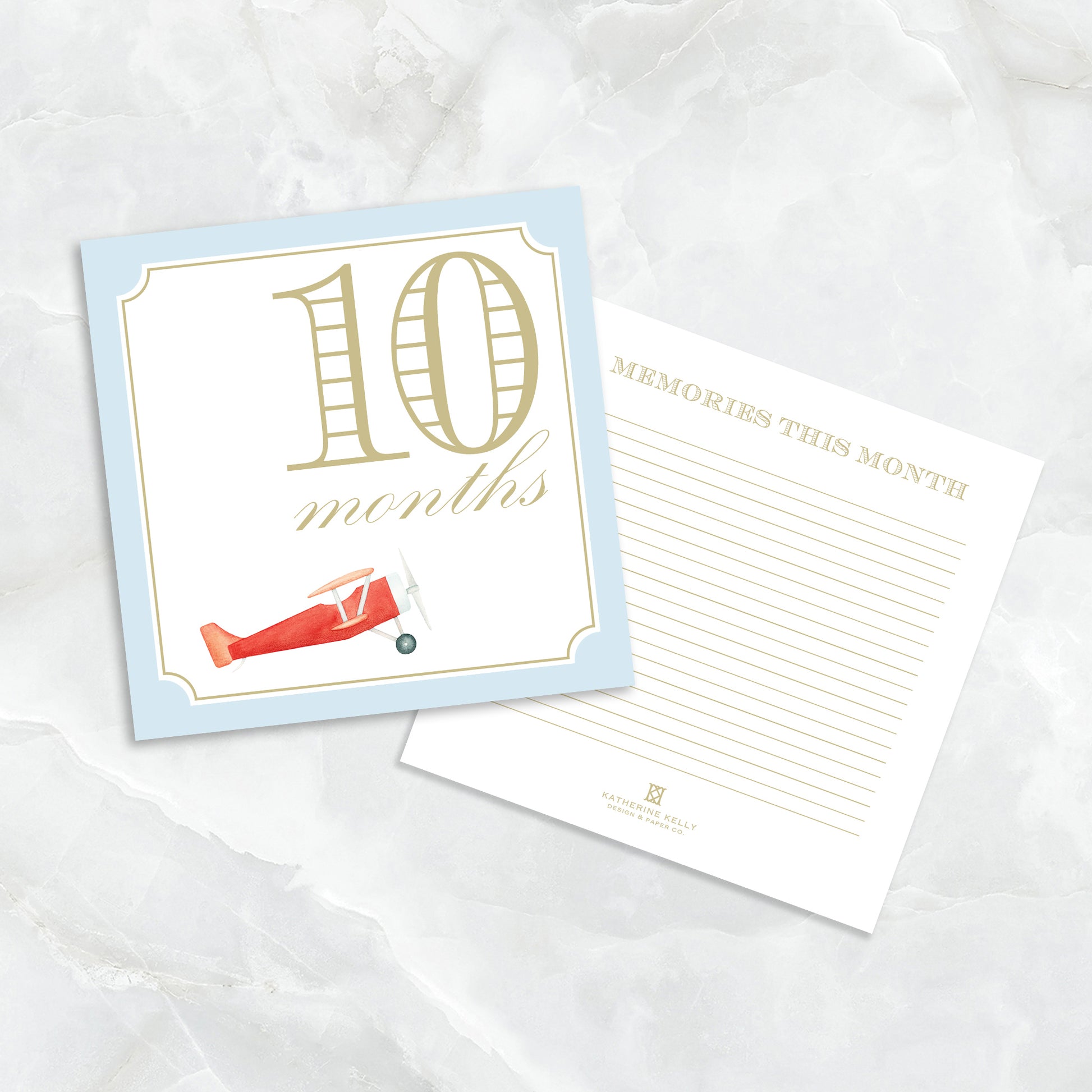 Blue baby milestone card set by Katherine Kelly showing numbered milestone cards for boys with playful designs.