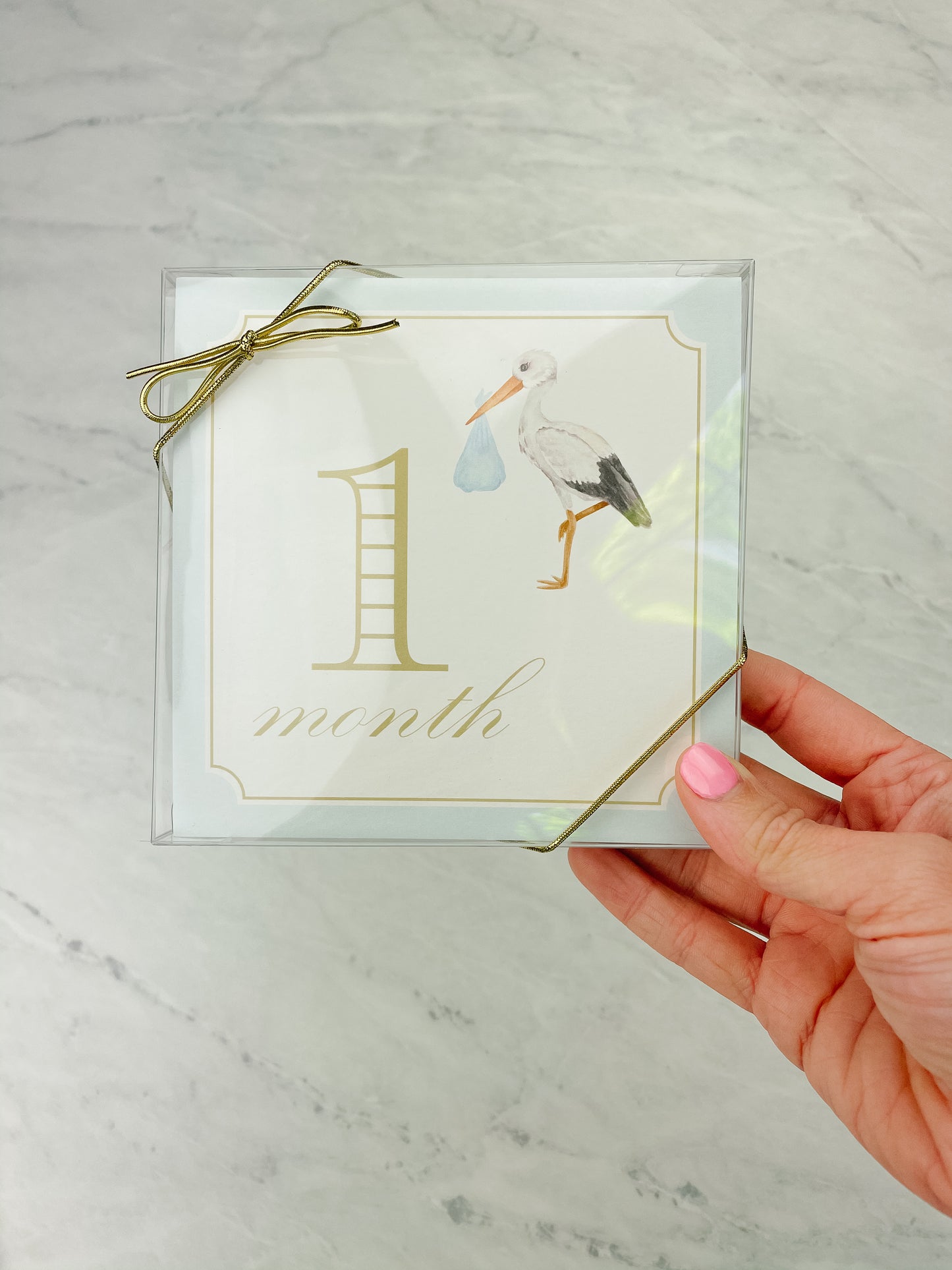 Blue baby milestone card box set by Katherine Kelly, featuring a collection of milestone cards for boys in a packaged box.