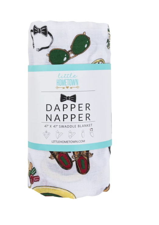 Baby wrapped in a Dapper Napper Swaddle Blanket by Little Hometown, showcasing soft, cozy fabric and stylish design.