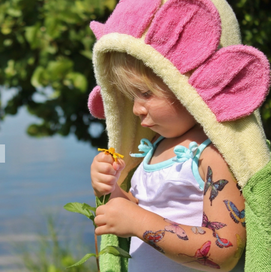 Kids flower hooded towel by Yikes Twins featuring a colorful floral pattern and a cozy hood for children.