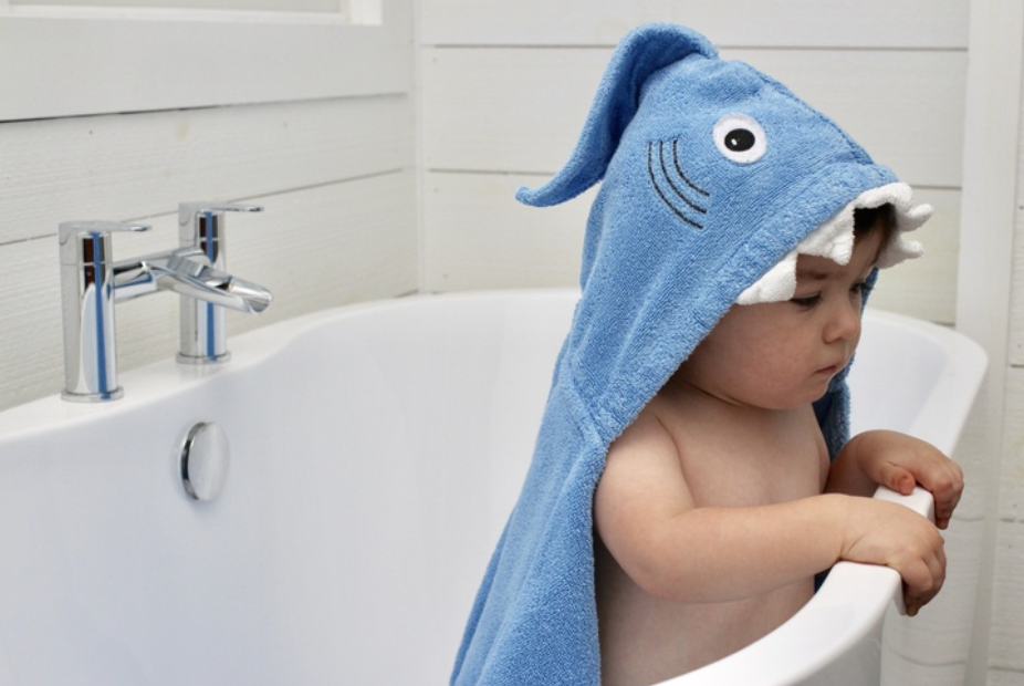 Kids Shark Hooded Towel by Yikes Twins featuring a shark design with a hood and soft fabric, perfect for drying off after swimming.